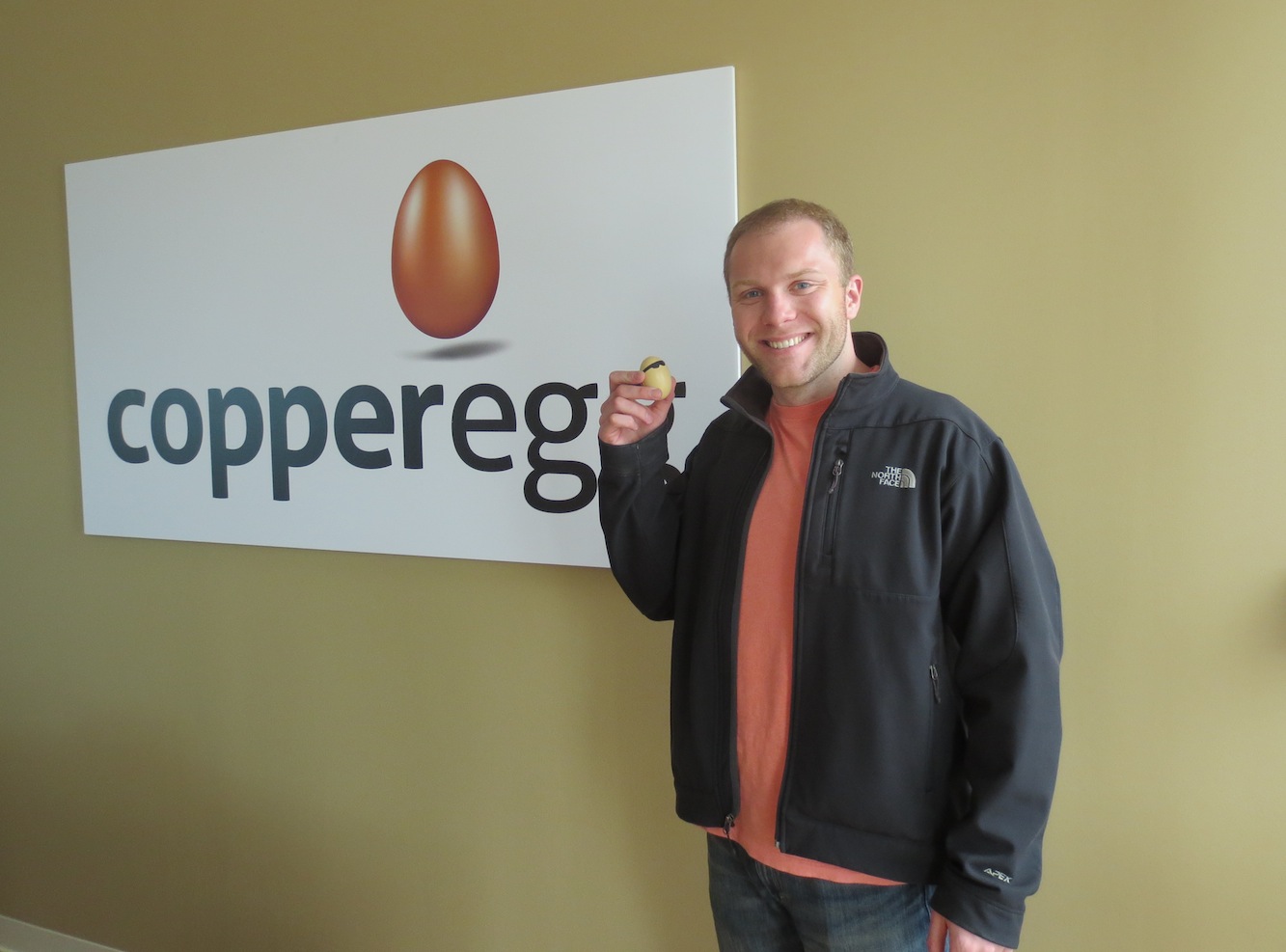 Matt Makai holding "The Egg" next to CopperEgg's logo
