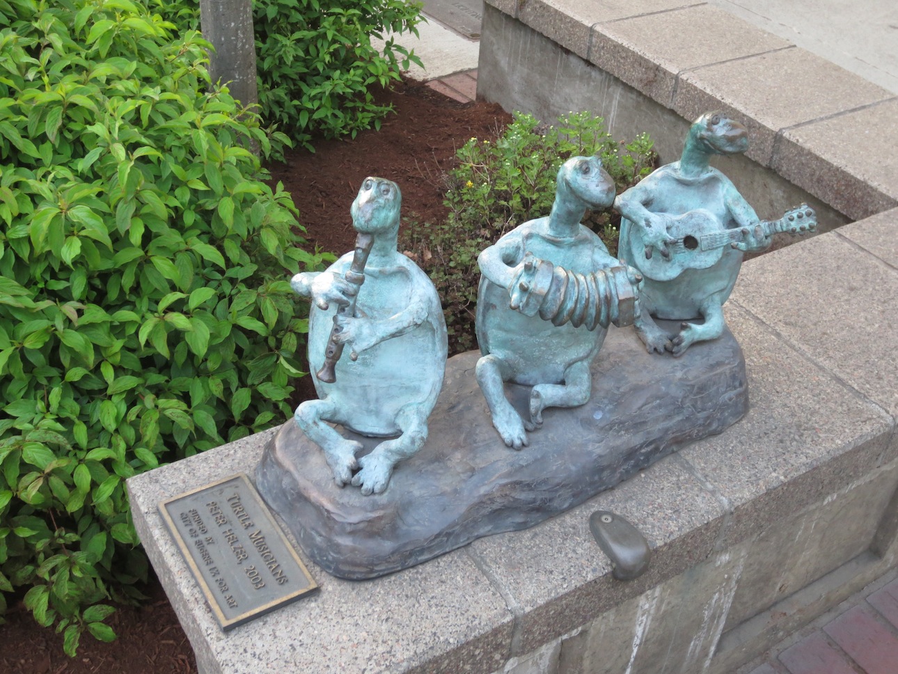 Statue of musical instrument playing turtles.