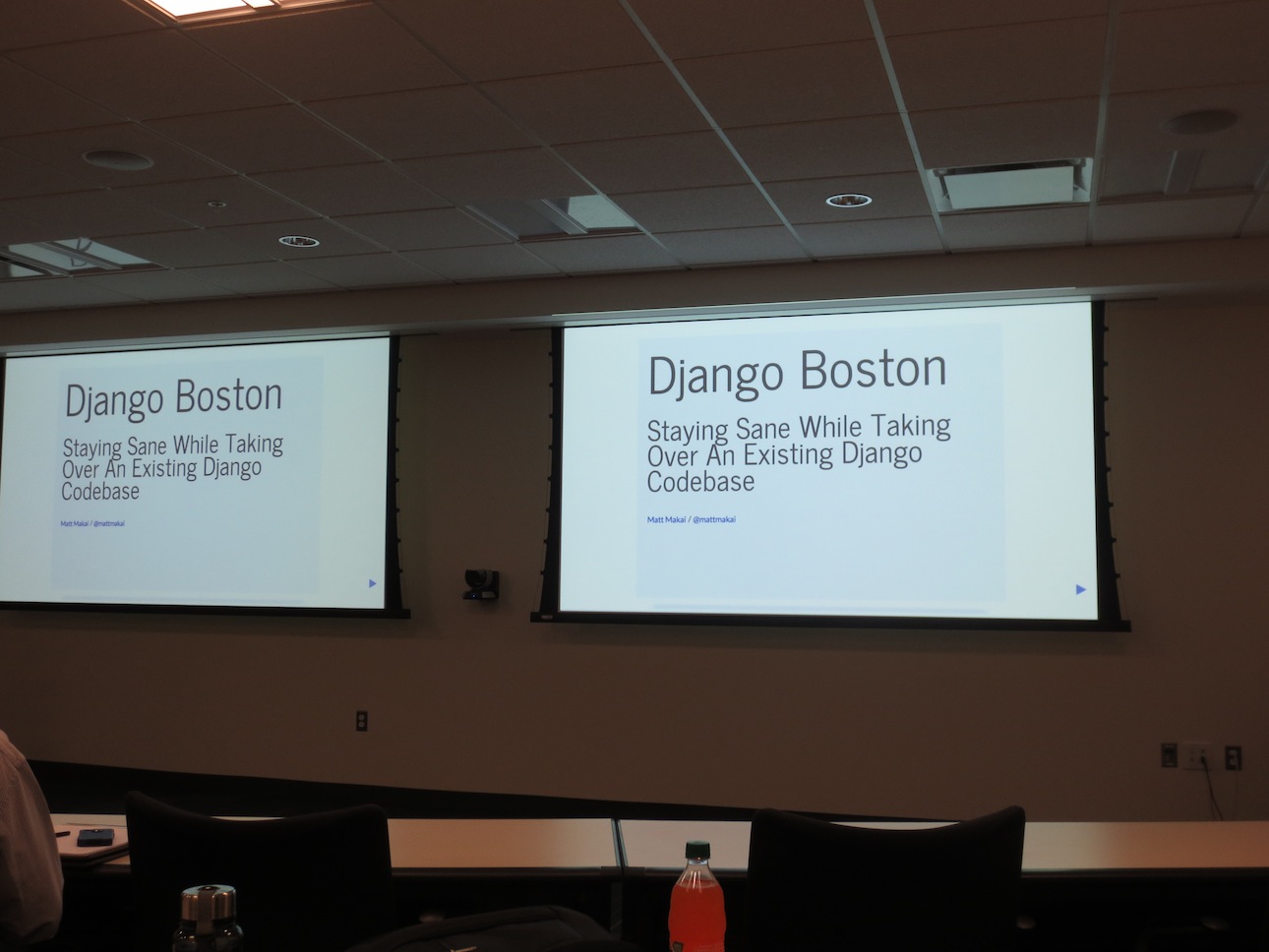 Django Boston presentation slides projected on the screen.