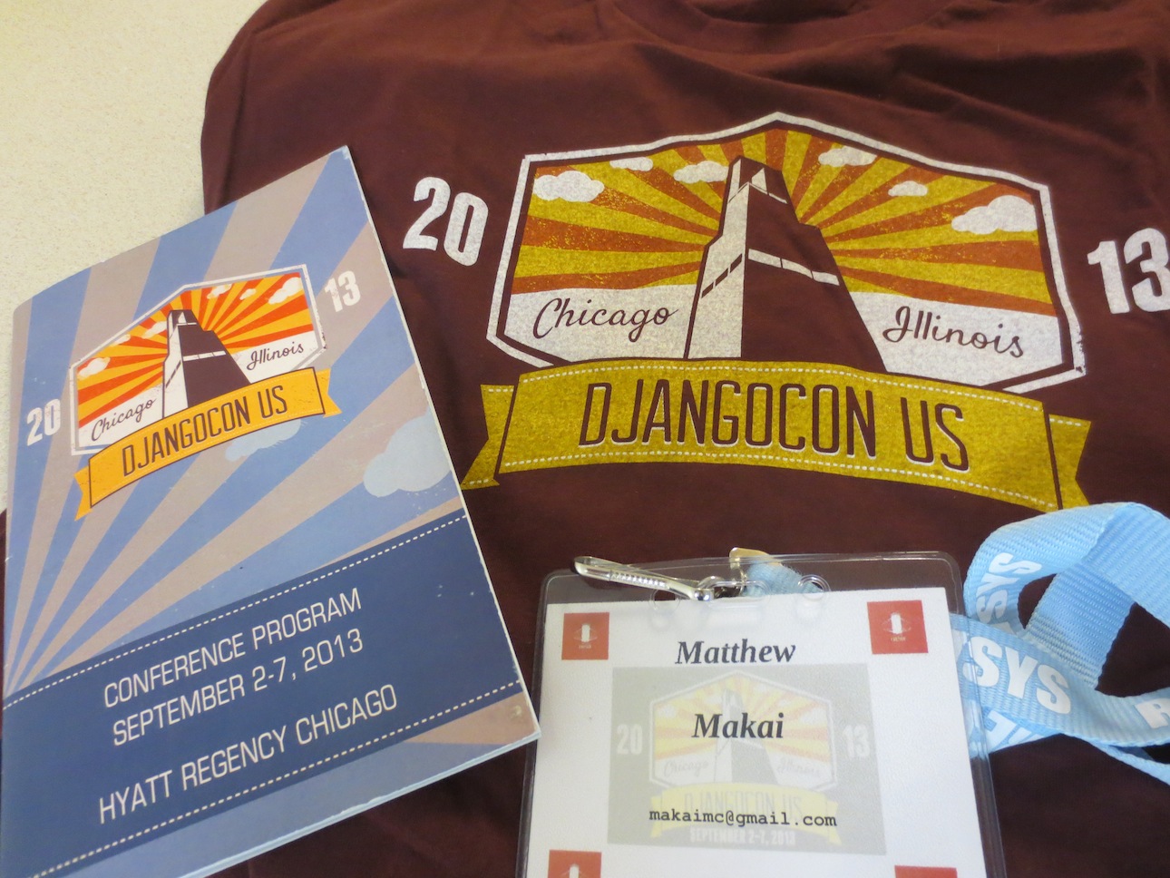 DjangoCon t-shirt, conference program, and attendee lanyard.