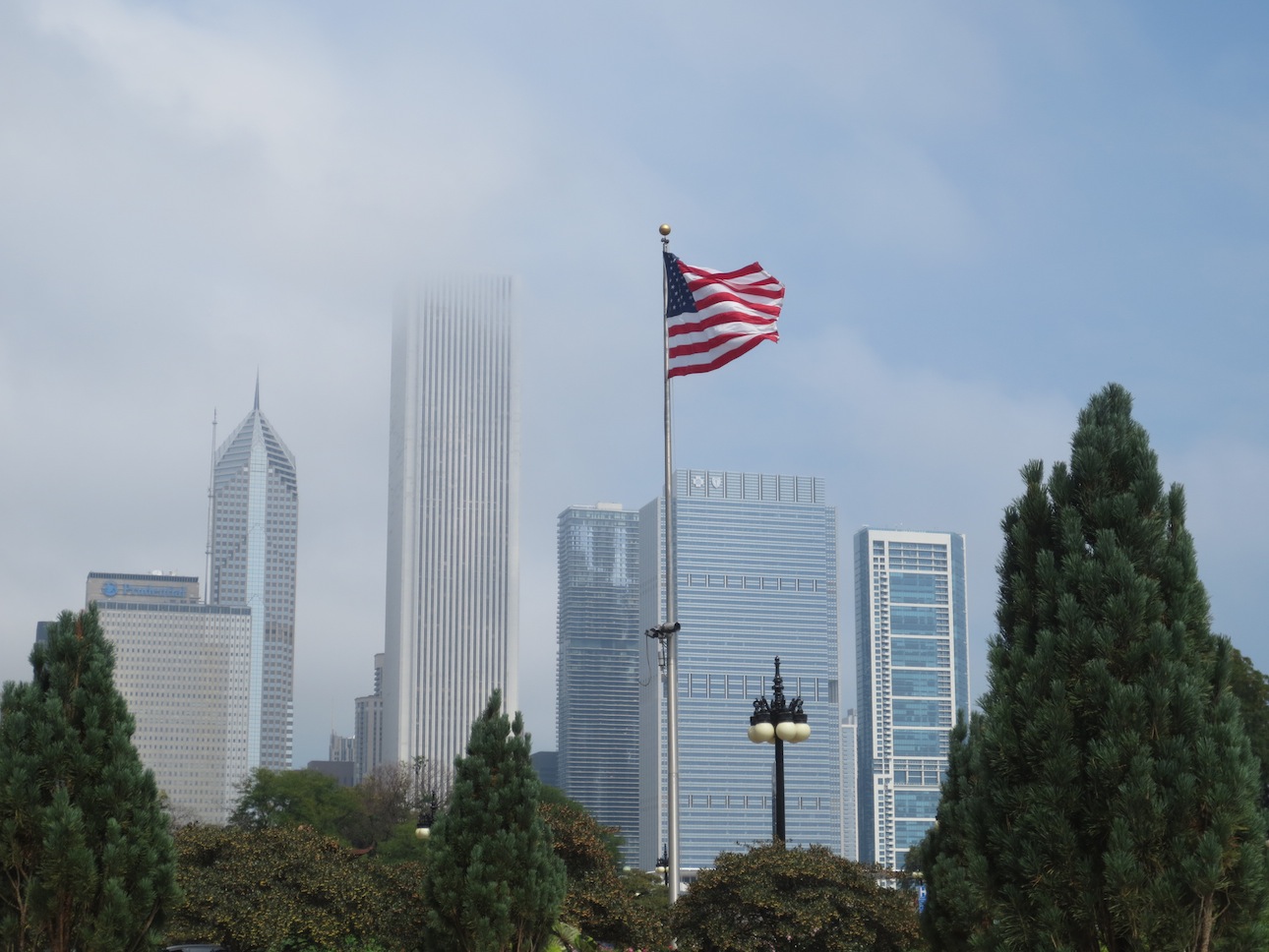American flag in front of Chicago buildings.