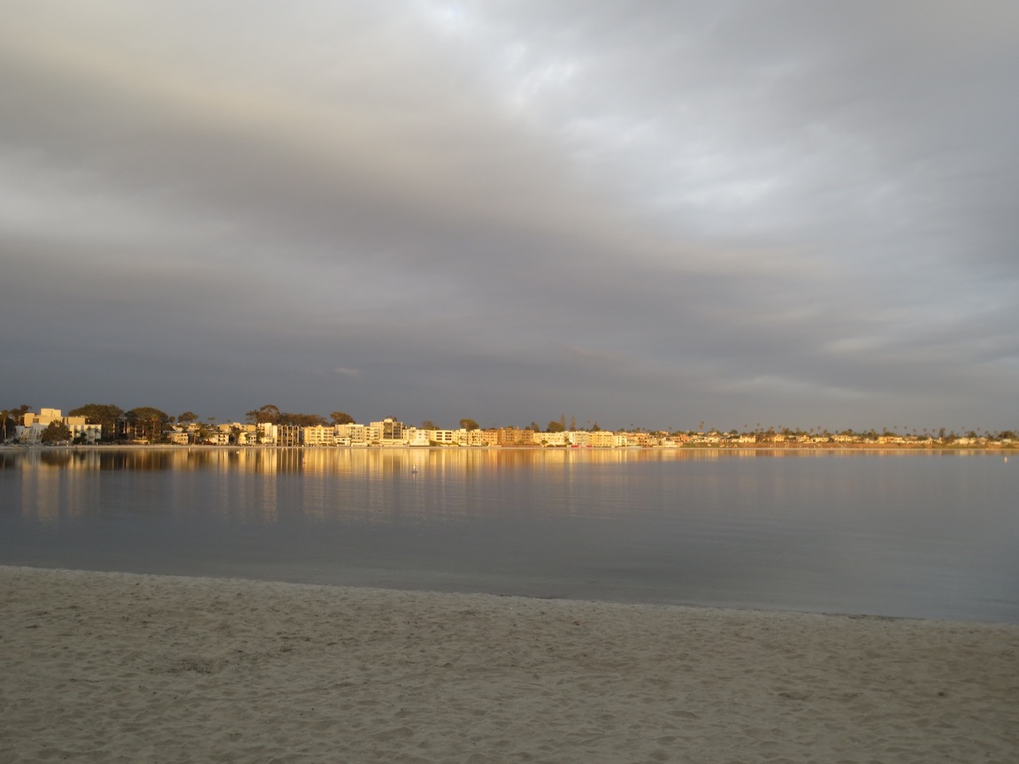 Sunlight breaks through the clouds at Pacific Beach on the Bay side