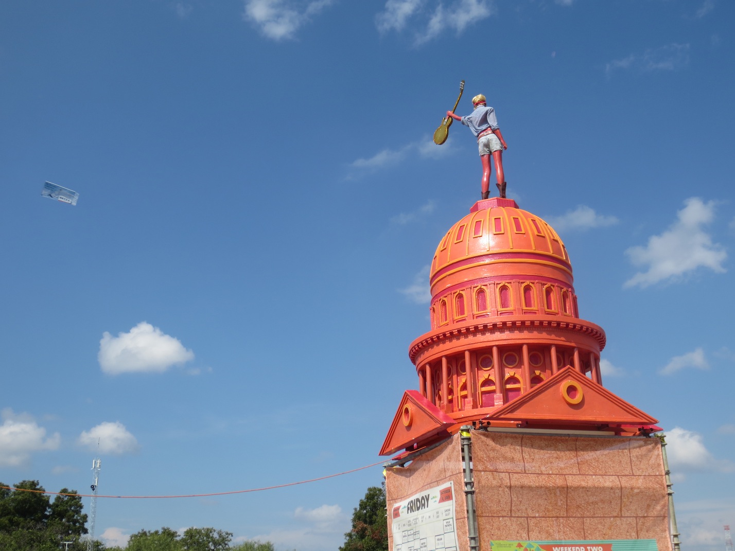 Statue on top of an orange painted version of the State Capitol.